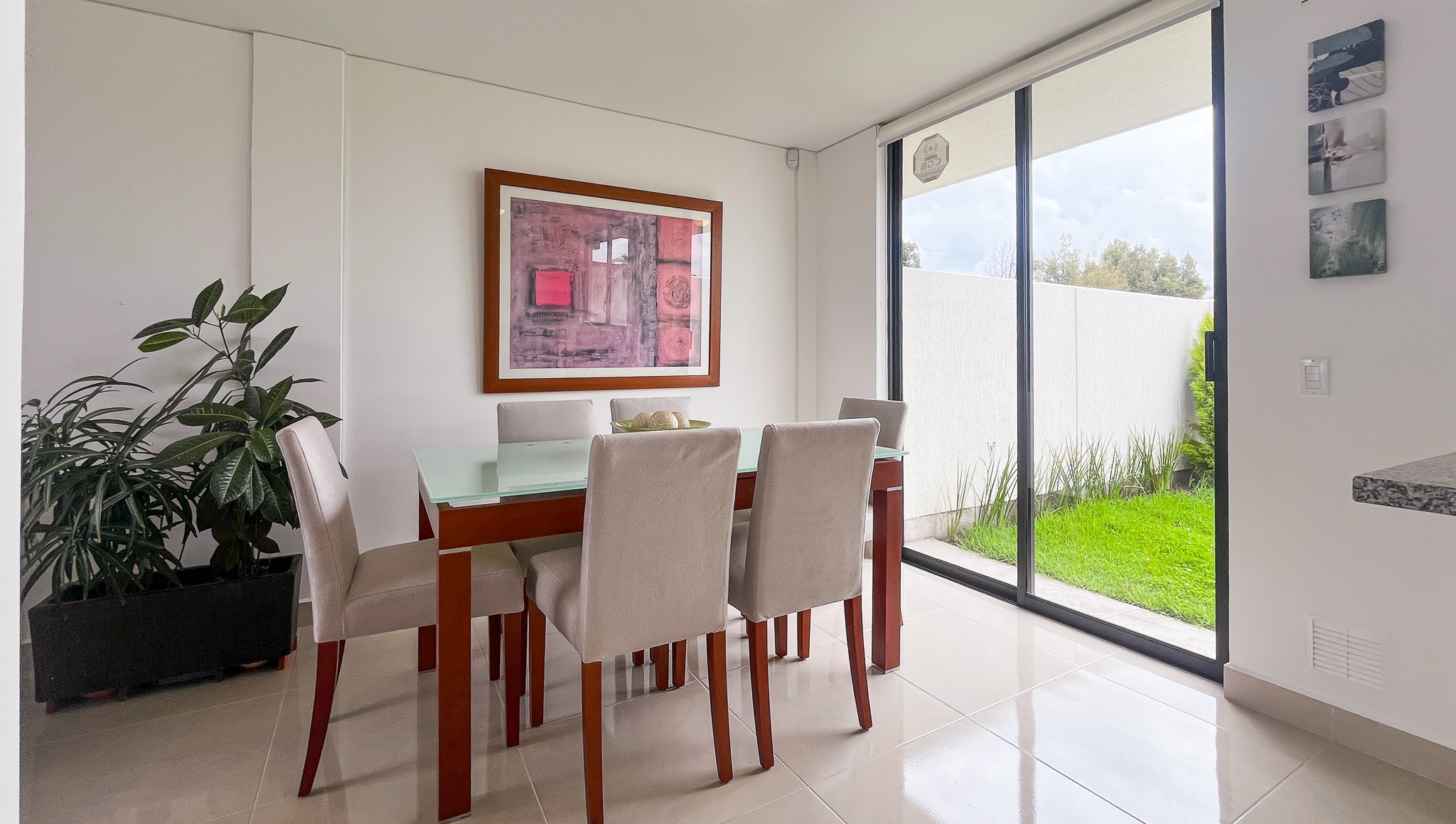 Comedor de mesa con seis sillas junto a una ventana que da al jardín, El Dean