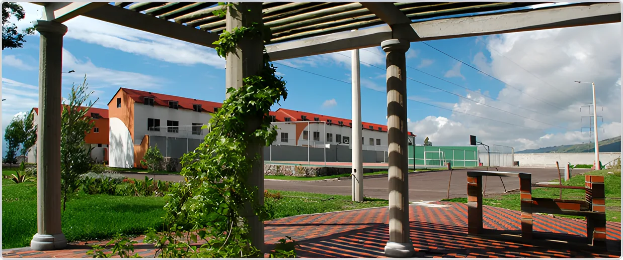 Pérgola de piedra con enredaderas frente a las casas del conjunto, Ciudad Jardín 2